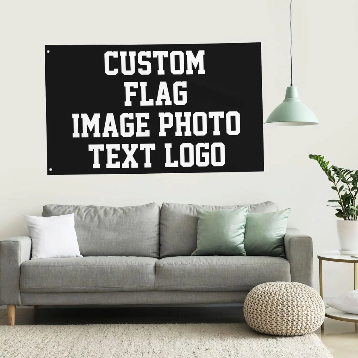 A black sign with white text that reads Custom Flag Image Photo Text Logo hanging on a wall above a gray sofa.