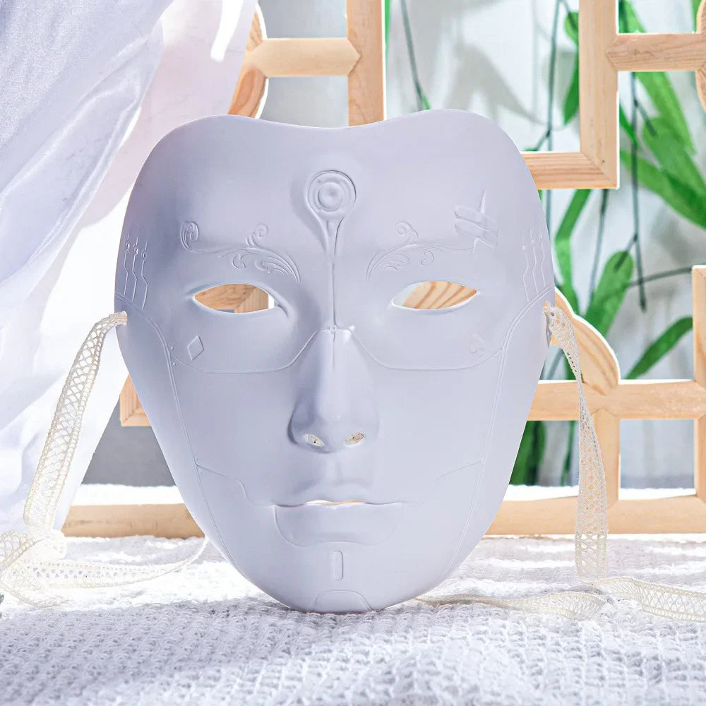 A light gray ancient style masquerade mask with intricate facial details resting on a white textured cloth.
