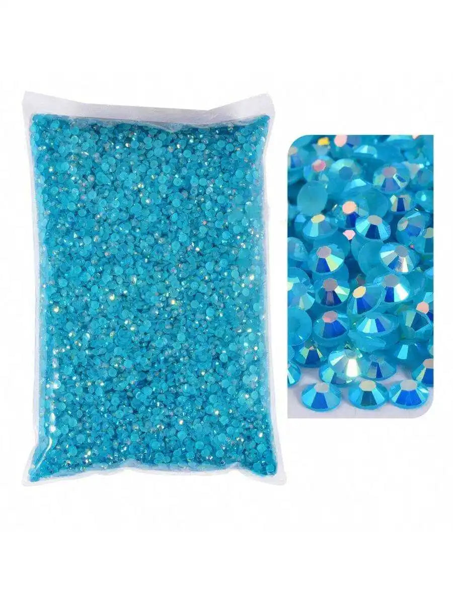 A bag of bright turquoise blue resin rhinestones with flatbacks and varying sizes.