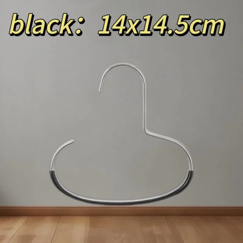 A silver hat organizer rack with a curved hook shape mounted on a wall.