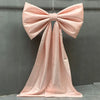 A pink satin bow with a long tulle drape displayed against a gray background for event decor.