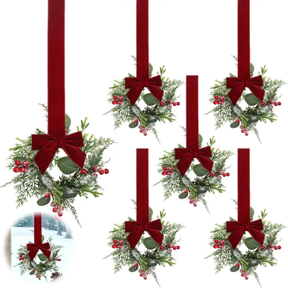 A 10-inch artificial Christmas wreath decorated with red berries and a velvet bow on a red ribbon.