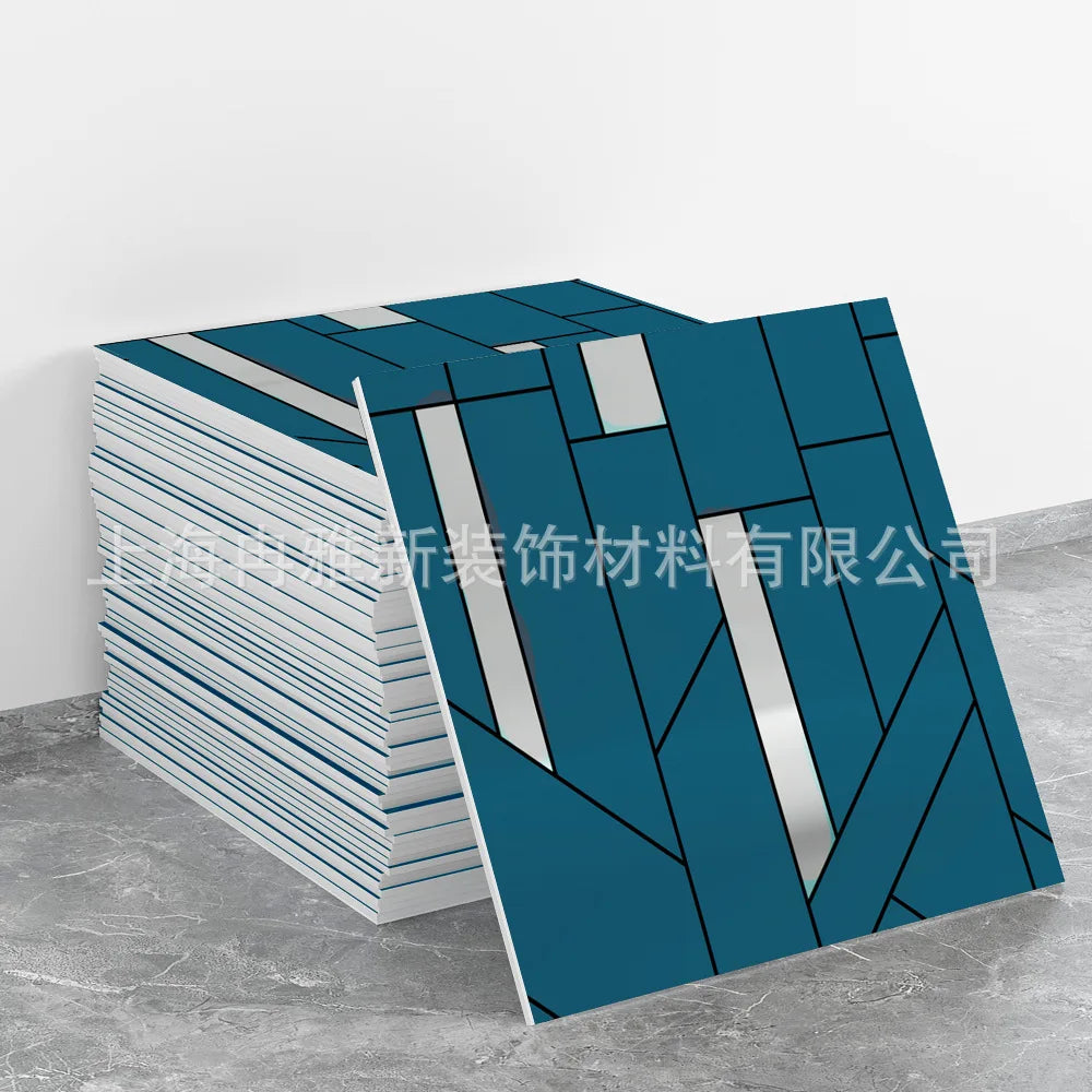 A stack of blue and white marble peel-and-stick tile stickers with gold accents displayed on a gray surface.
