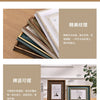 A stack of handcrafted wooden photo frames and a single framed artwork displayed on a wooden surface.