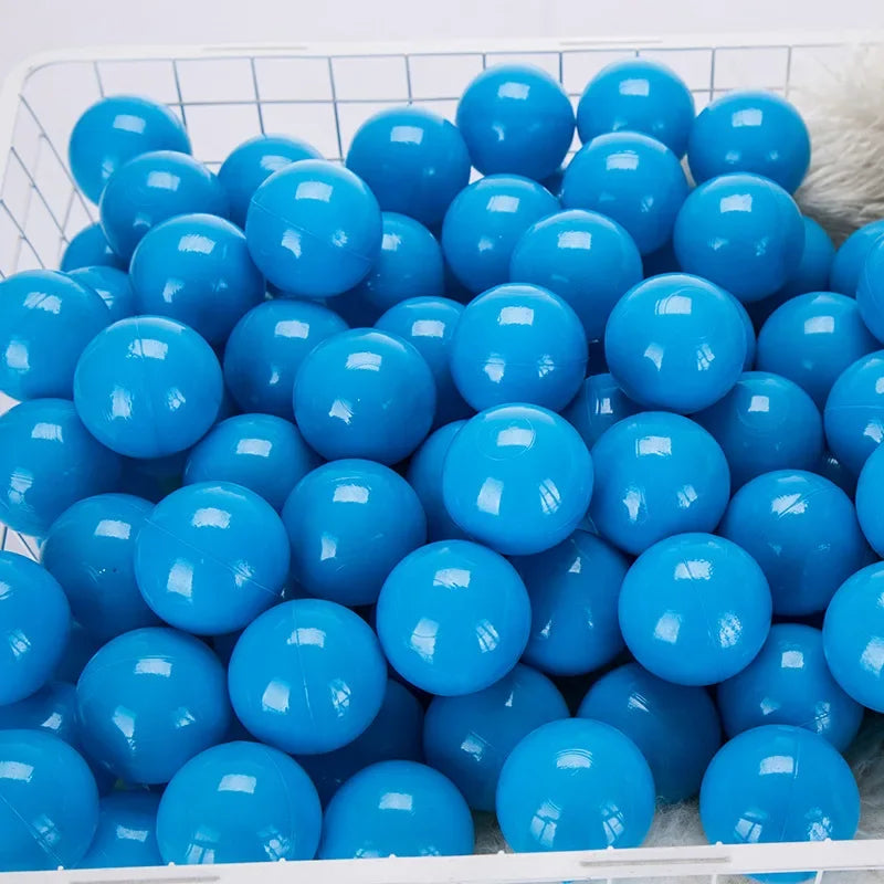 A large quantity of bright blue, glossy, spherical plastic balls for play areas.
