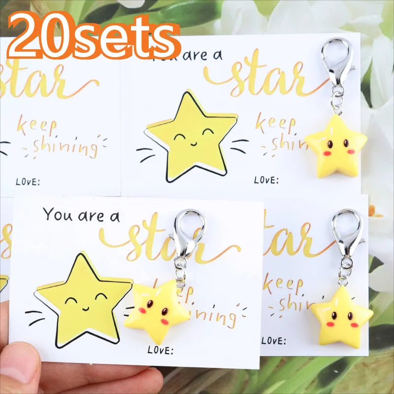 A set of 20 inspirational star keychains featuring yellow and gold glitter designs on white cards.