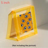 A clear yellow acrylic photo frame with a patterned message board inside.