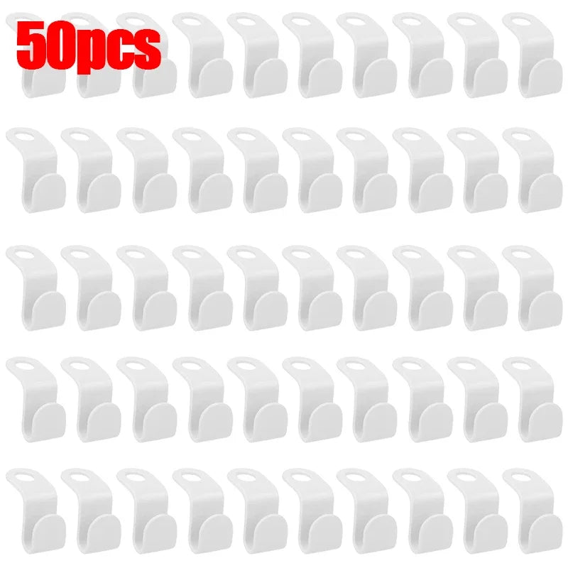 A set of 30 white space-saving hanger connector hooks for organizing and hanging items.