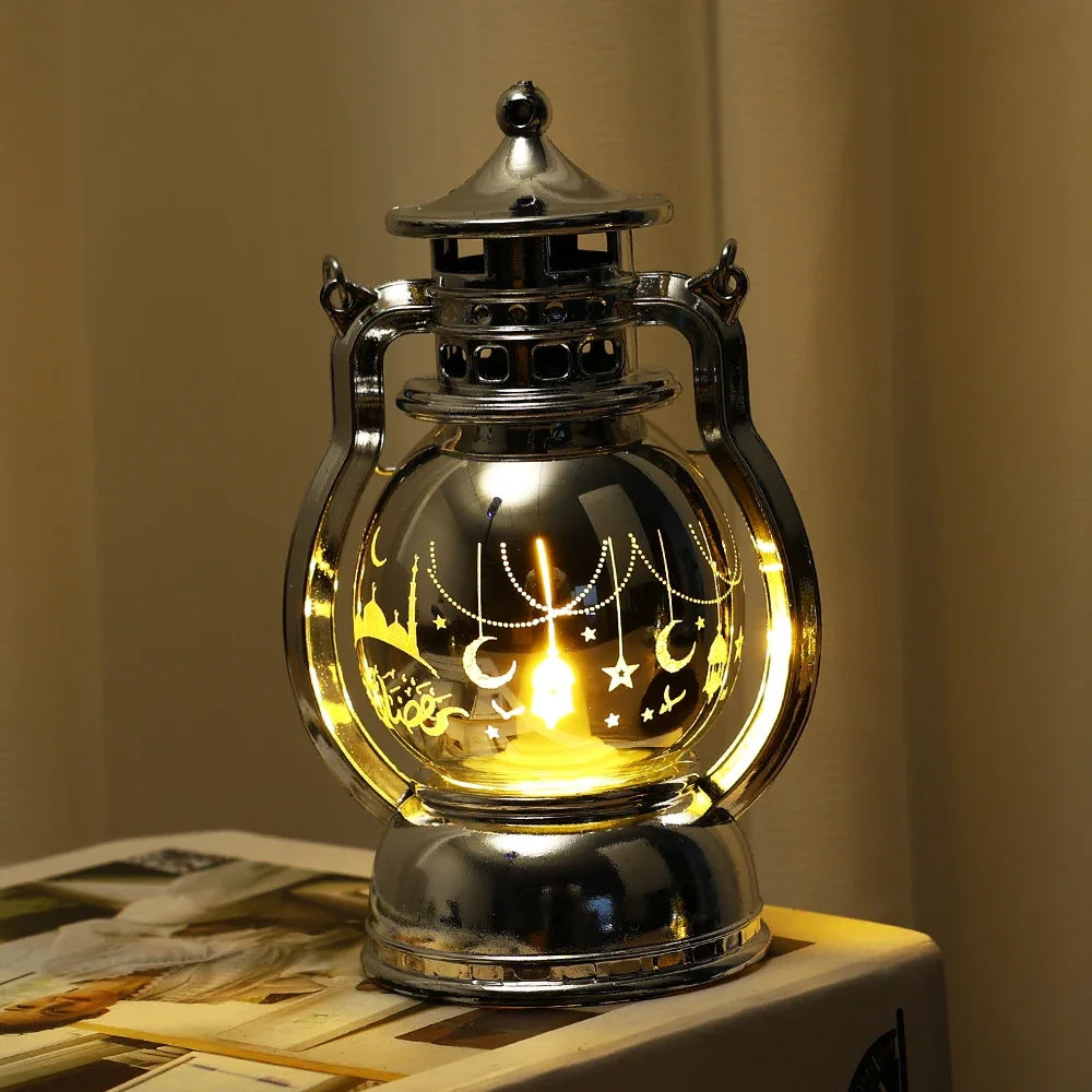 A silver LED lantern night light with a glass globe and decorative elements, emitting a warm glow.