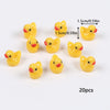 A collection of 20 small yellow resin duck figurines used for crafts and decor.