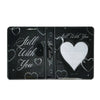A black transparent photocard album featuring a 'Still With You' design with heart and chain motifs.