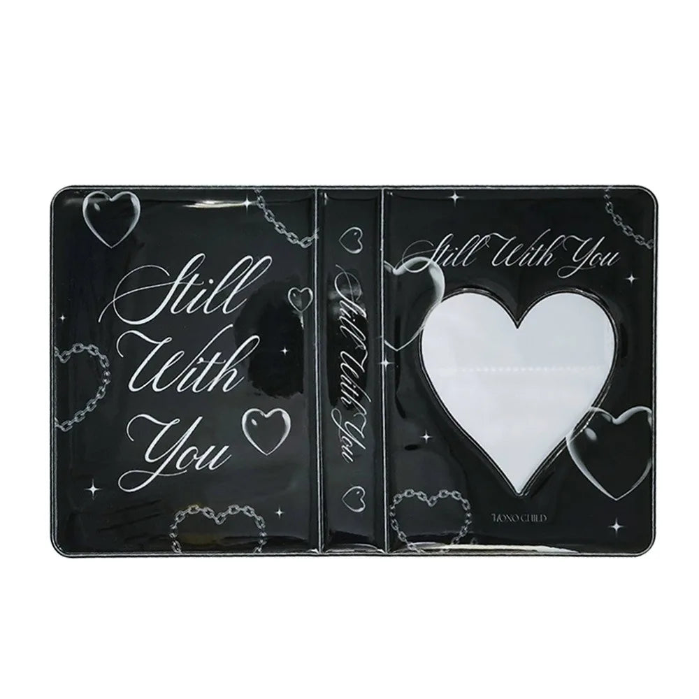 A black transparent photocard album featuring a 'Still With You' design with heart and chain motifs.