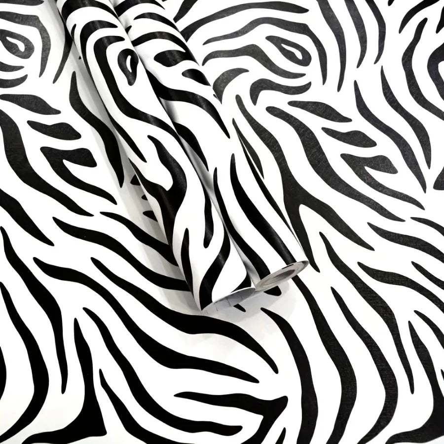 Rolls of zebra print self-adhesive peel and stick wallpaper on a white background.