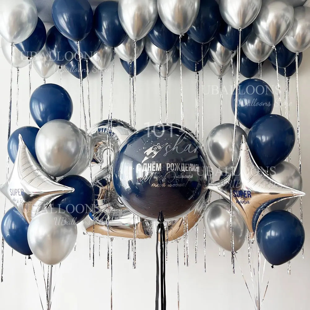 A collection of navy blue and gold metallic balloons with pearl finishes hanging in a vertical display.