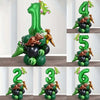 A set of green balloons shaped like numbers 1 through 6 with small dinosaur figures for a birthday party theme.