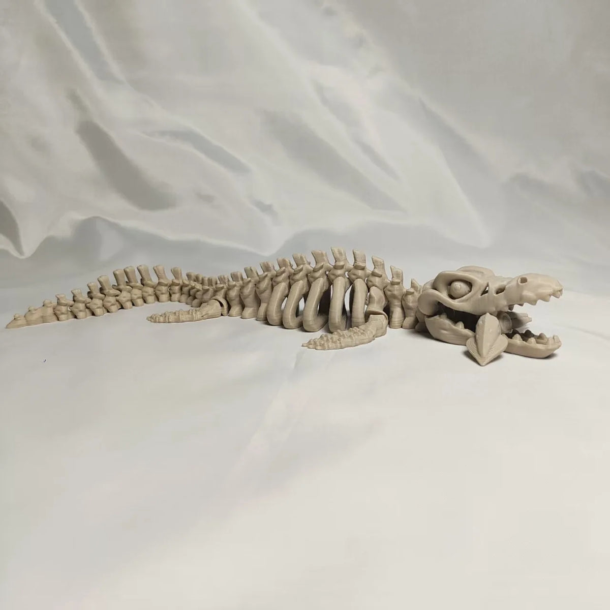 A 3D printed dinosaur skeleton figurine featuring a T-Rex and Mosasaurus collectible.