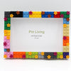 A colorful photo frame made from interlocking plastic blocks featuring various star shapes and bright colors.