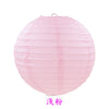 A round pink paper lantern with vertical folds.