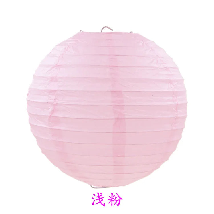 A round pink paper lantern with vertical folds.