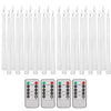 A set of white flameless taper candles with remote controls and timers shown alongside battery packs.