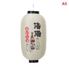 A large, cylindrical Japanese paper hanging lantern with black accents and Japanese characters.