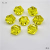 Six yellow crystal ice cube acrylic stones arranged on a white background.