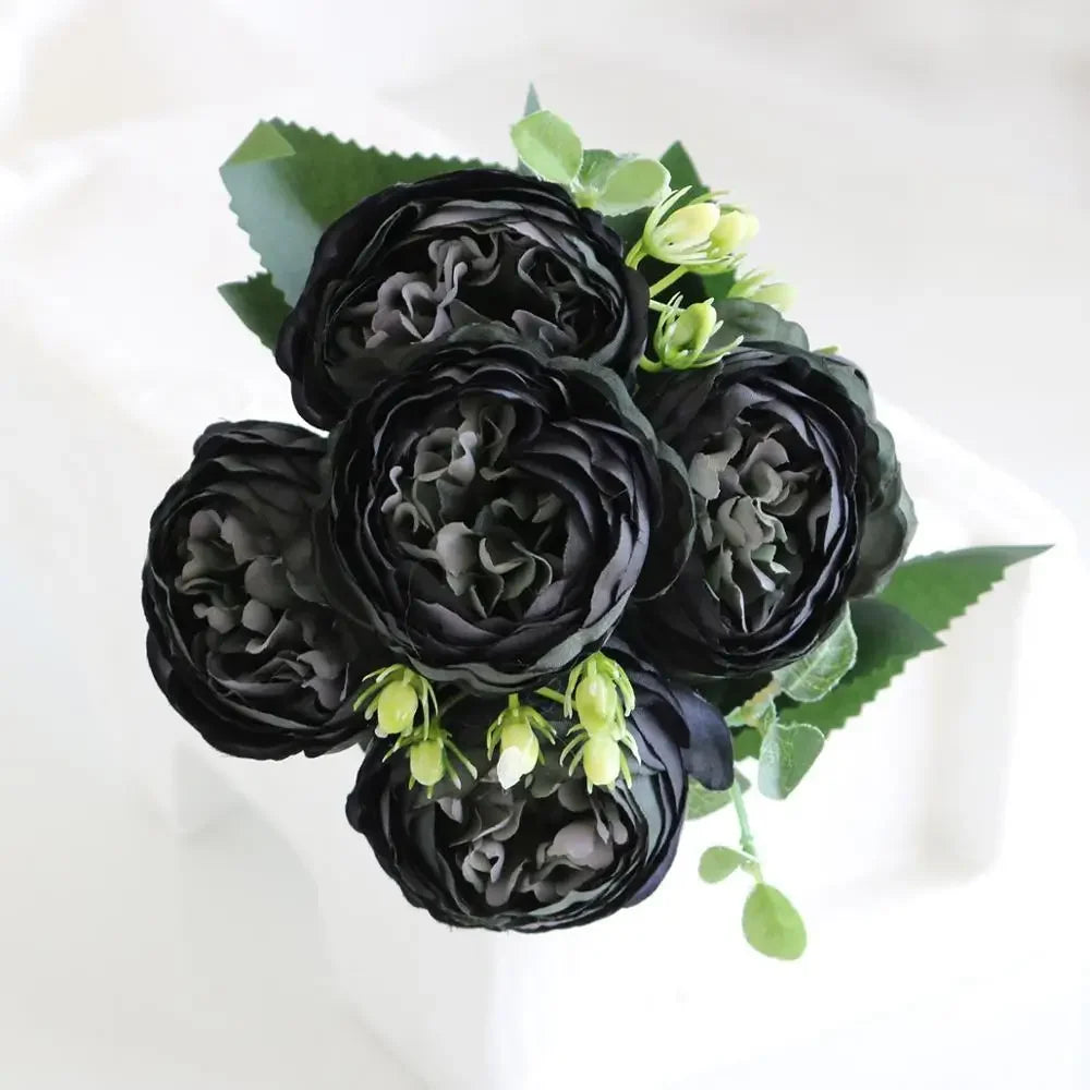 A dark purple silk rose and peony artificial bouquet featuring deep black flowers and green foliage.