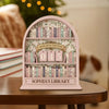 A pink wooden shelf display featuring books and a sign that reads Books Read This Year and Sophia's Library