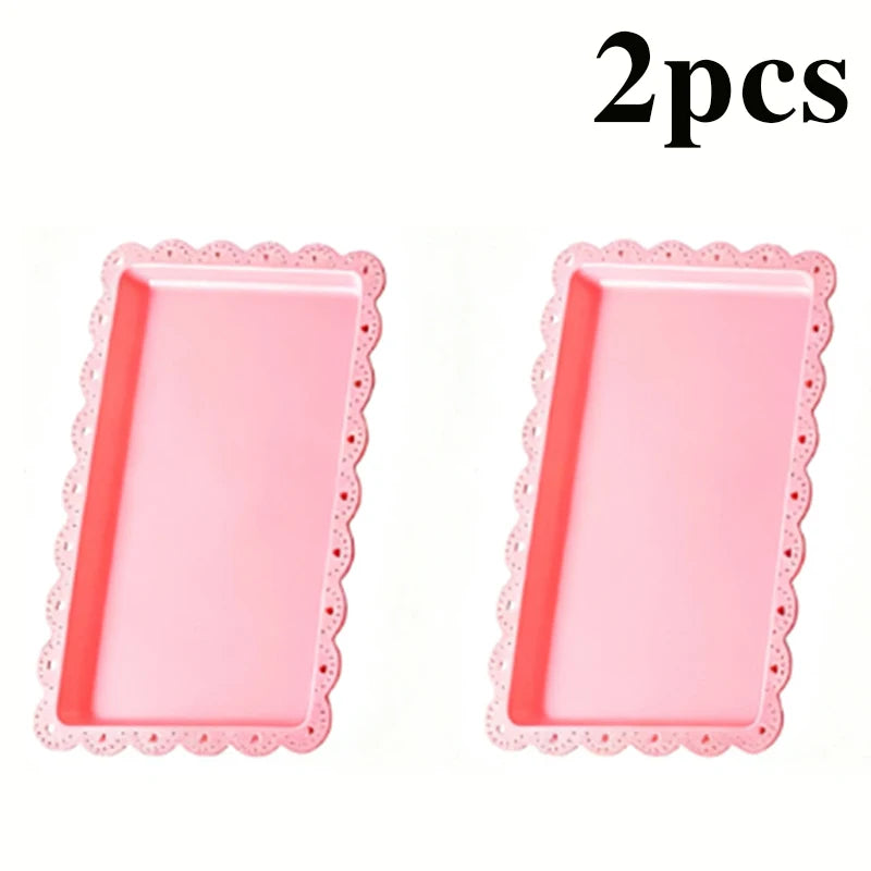 Two pink tiered dessert racks with scalloped edges for tea parties
