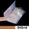 A transparent jewelry organizer storage bag filled with various gold and silver jewelry pieces.
