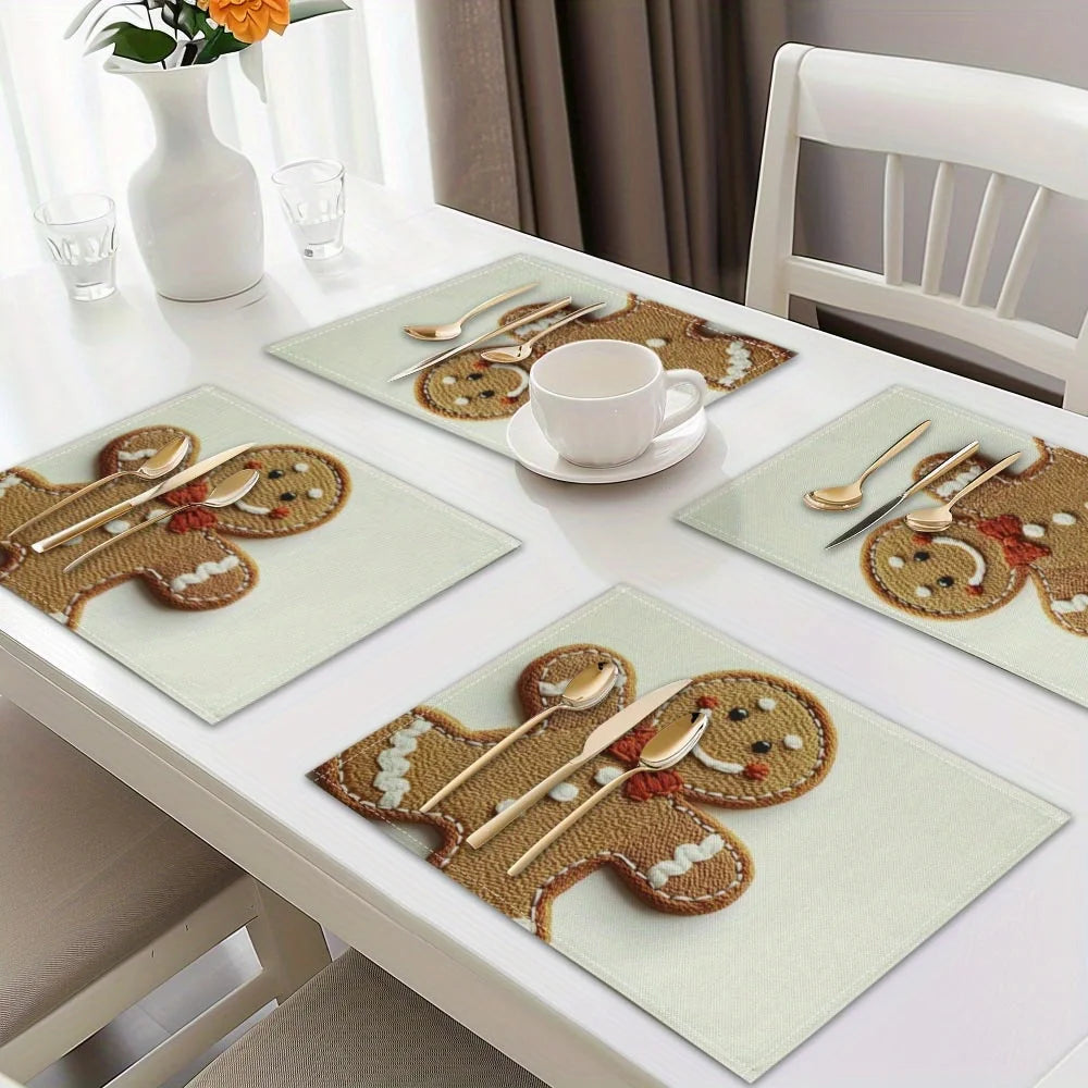 A set of four Christmas gingerbread man printed placemats with wooden utensils and a white teacup on a white table.