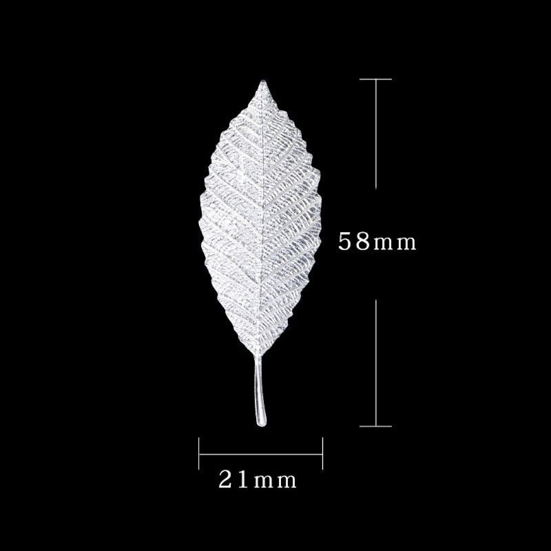 A single, detailed tea brewing leaf in sterling silver, shown against a black background with dimension lines.