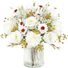 A bouquet of artificial silk white roses and daisies arranged in a clear glass vase.