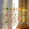 A hanging crystal sun catcher with various colored glass and quartz elements catching sunlight.