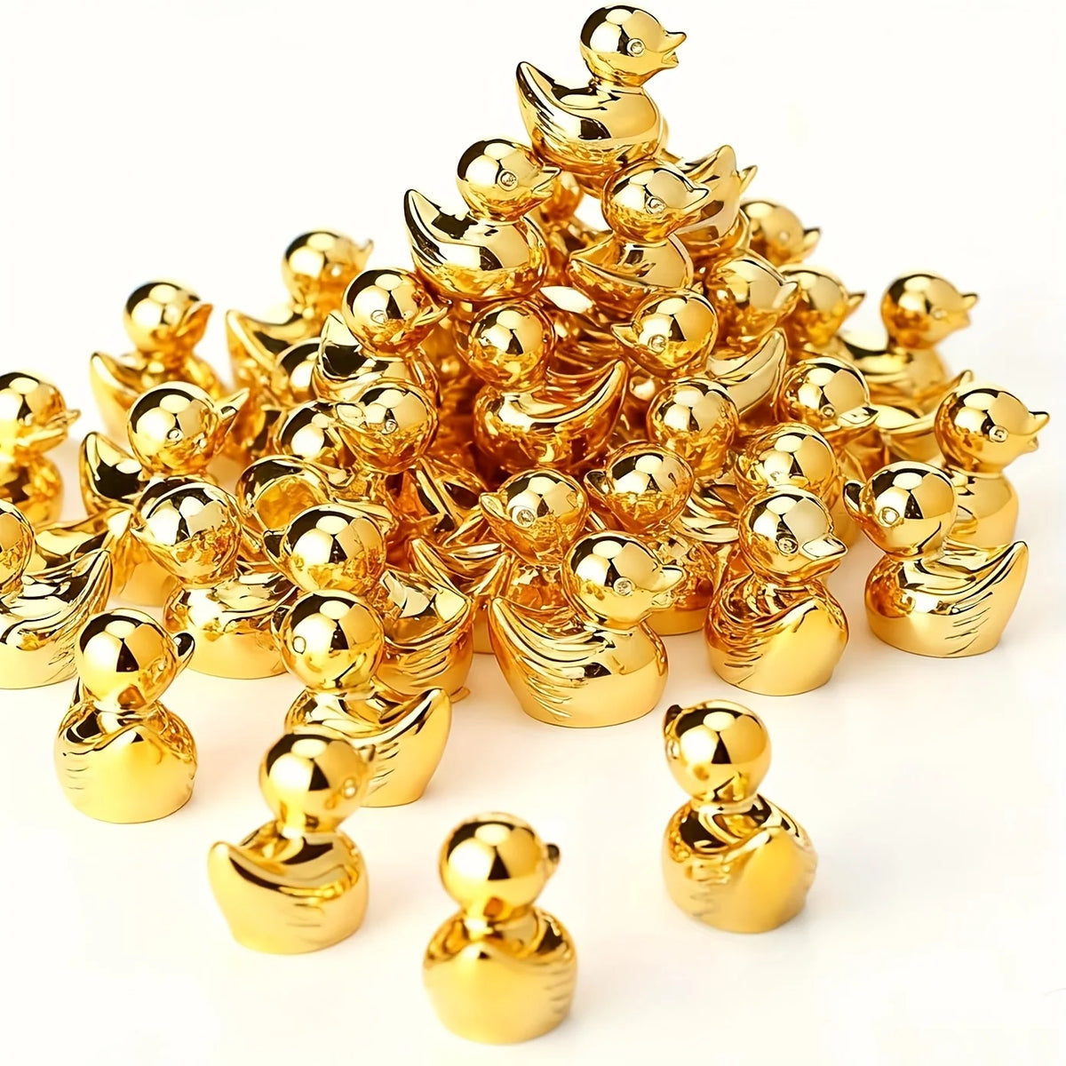 A pile of 20 miniature gold duck figurines for crafts and decor