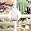 A set of thermal label paper rolls and related accessories for mini label printers are displayed on a shelf.