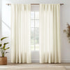 Cream natural linen sheer curtains hanging in a window with a wooden rod and a light rug below