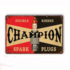 Vintage metal tin sign featuring the word CHAMPION with double ribbed spark plugs text