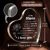A clear acrylic heart pendant engraved with the message I love you for mom