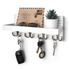 A rustic wooden key holder organizer displaying various keys and sunglasses on a white shelf.