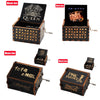 A collection of carved wooden music boxes featuring various band and artist themes like Queen, Friends, and Pink Panther.