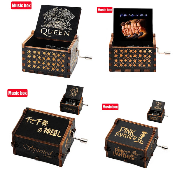 Collection de boîtes à musique en bois sculpté avec des thèmes d'artistes variés comme Queen, Friends et Pink Panther.