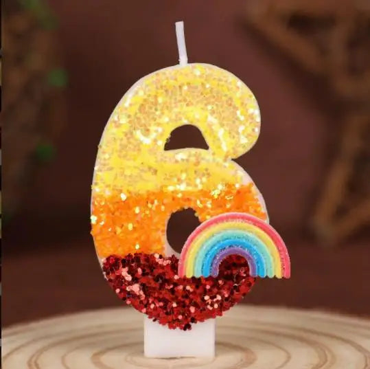 Rainbow sequined number candles shaped like the number 6 with a rainbow base