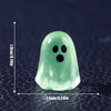 A translucent green ghost figurine with two black eyes, shown against a dark background.