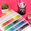 A collection of dual-ended watercolor art markers in various colors arranged on a white tray and in a black container.