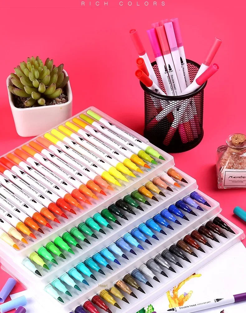 A collection of dual-ended watercolor art markers in various colors arranged on a white tray and in a black container.