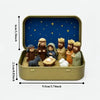 Miniature nativity scene set featuring Mary, Jesus, shepherd, and animal figurines displayed in a gold-colored box.