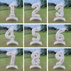 A set of white standing foil balloons featuring the number three and four with a crown design for birthday celebrations.