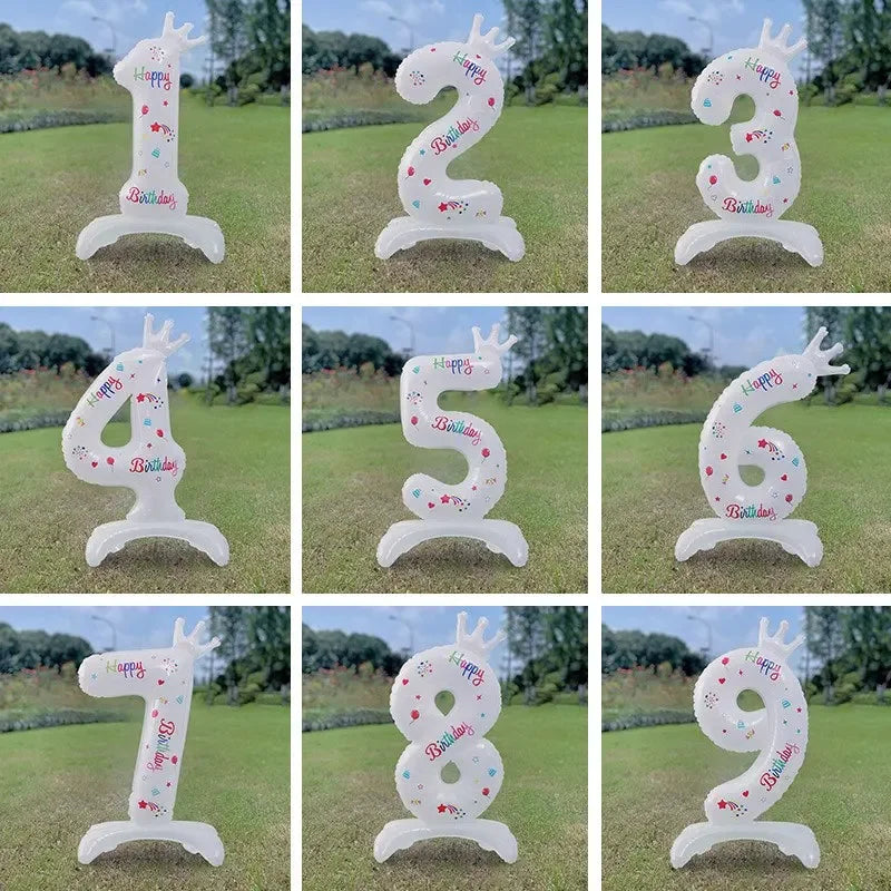 A set of white standing foil balloons featuring the number three and four with a crown design for birthday celebrations.