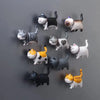 A collection of 10 3D cartoon cat refrigerator magnets in various colors and poses.